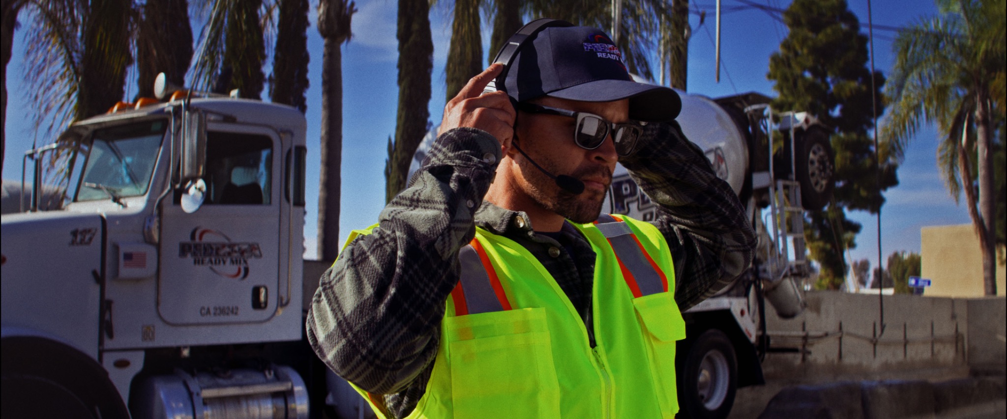 Utility professional wearing a Black and Gray communications headset in a cinematic field setting