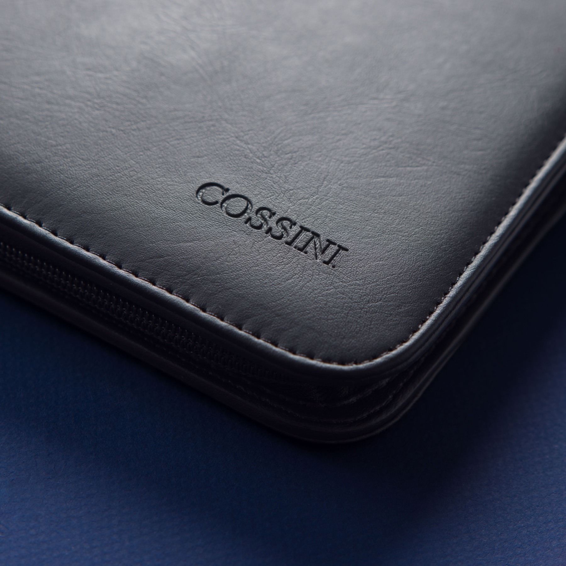 Close-up of Cossini leather, stitching and embossed branding