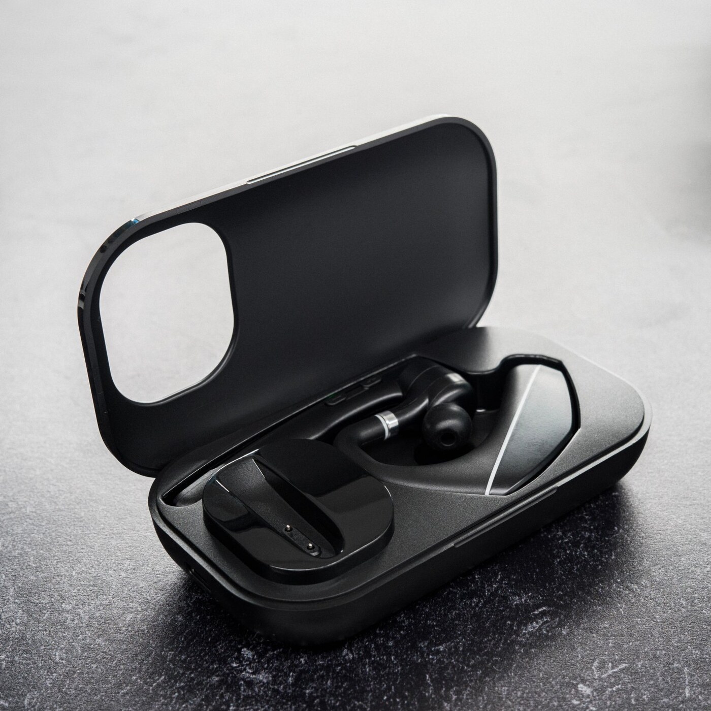 Black & Gray Bluetooth headset inside its charging case