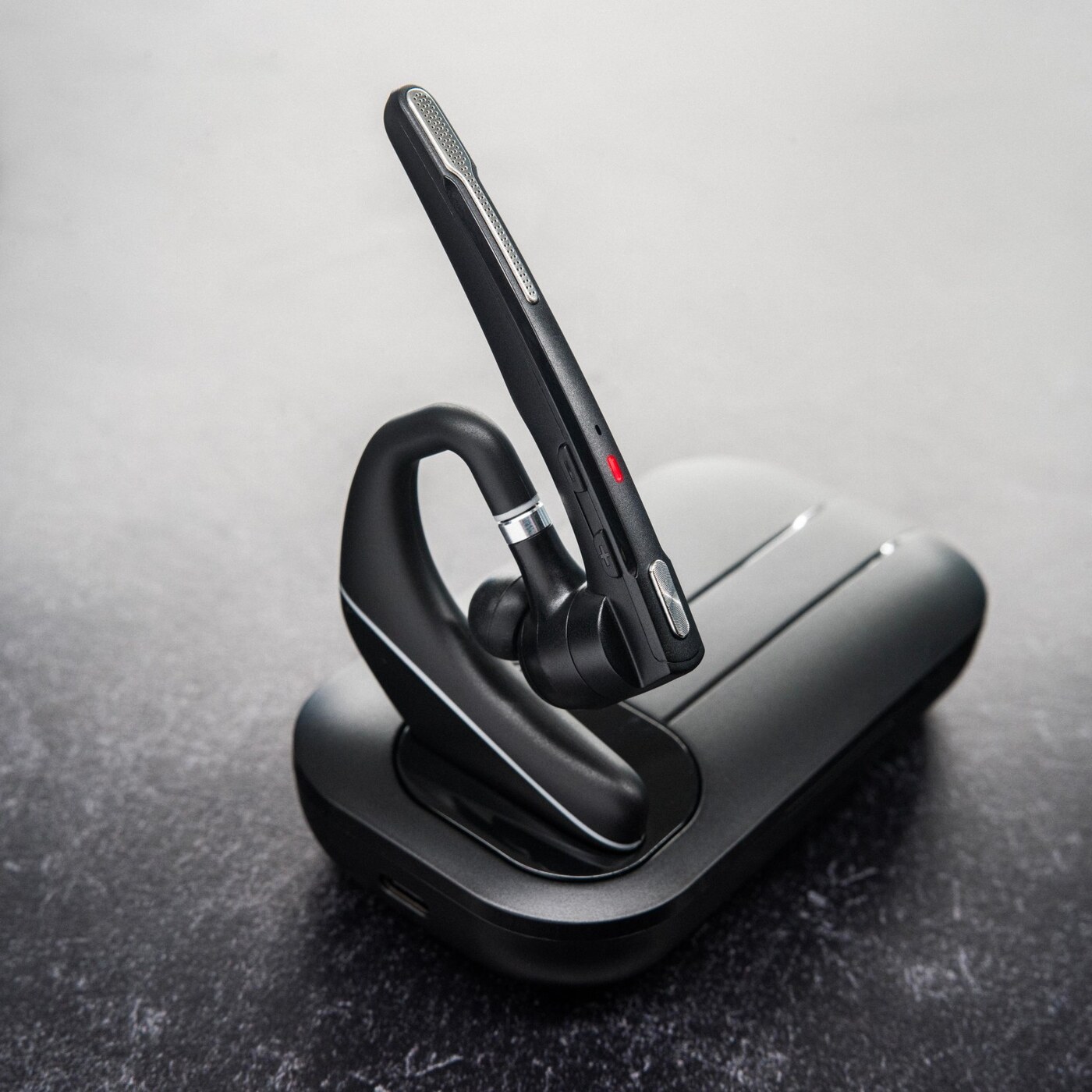 Black & Gray headset and charging dock from a second angle