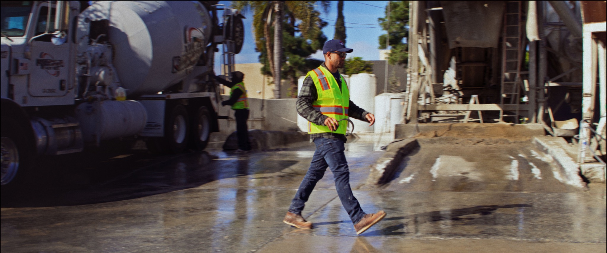 Worker crossing an industrial yard in a safety vest