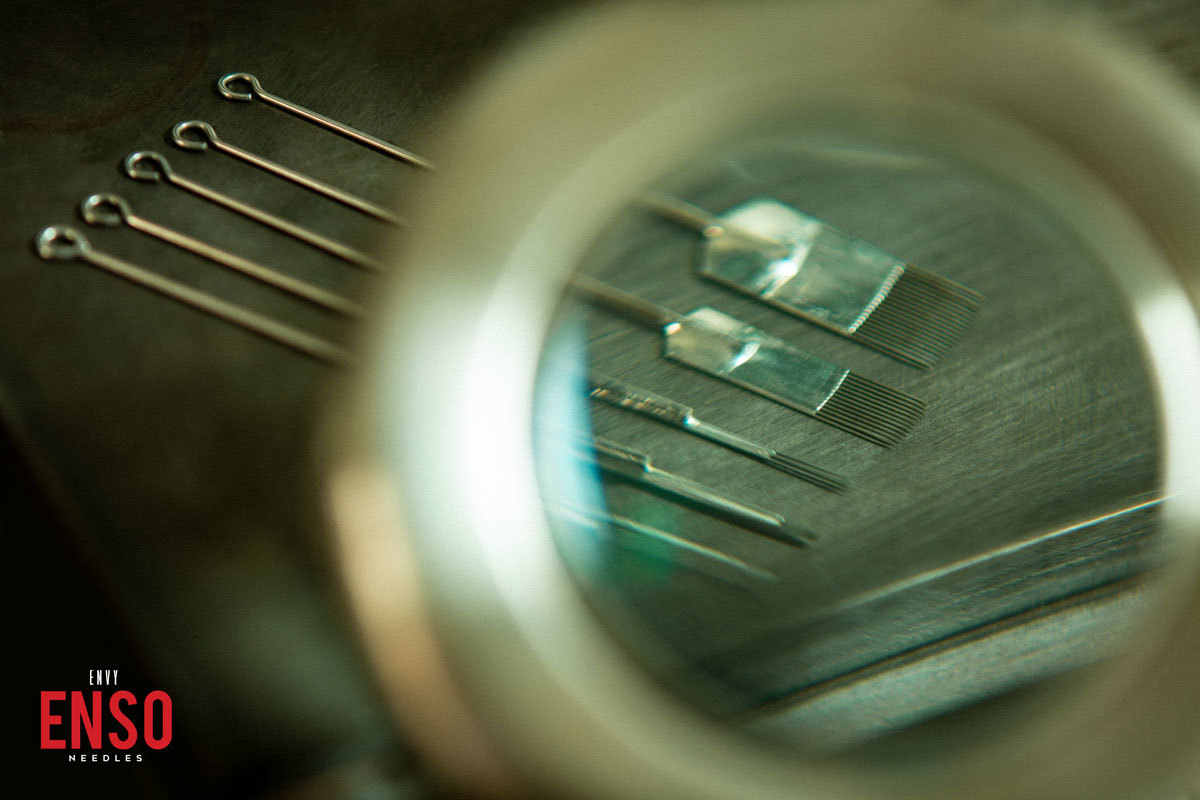 ENSO tattoo needles viewed through a magnifying lens
