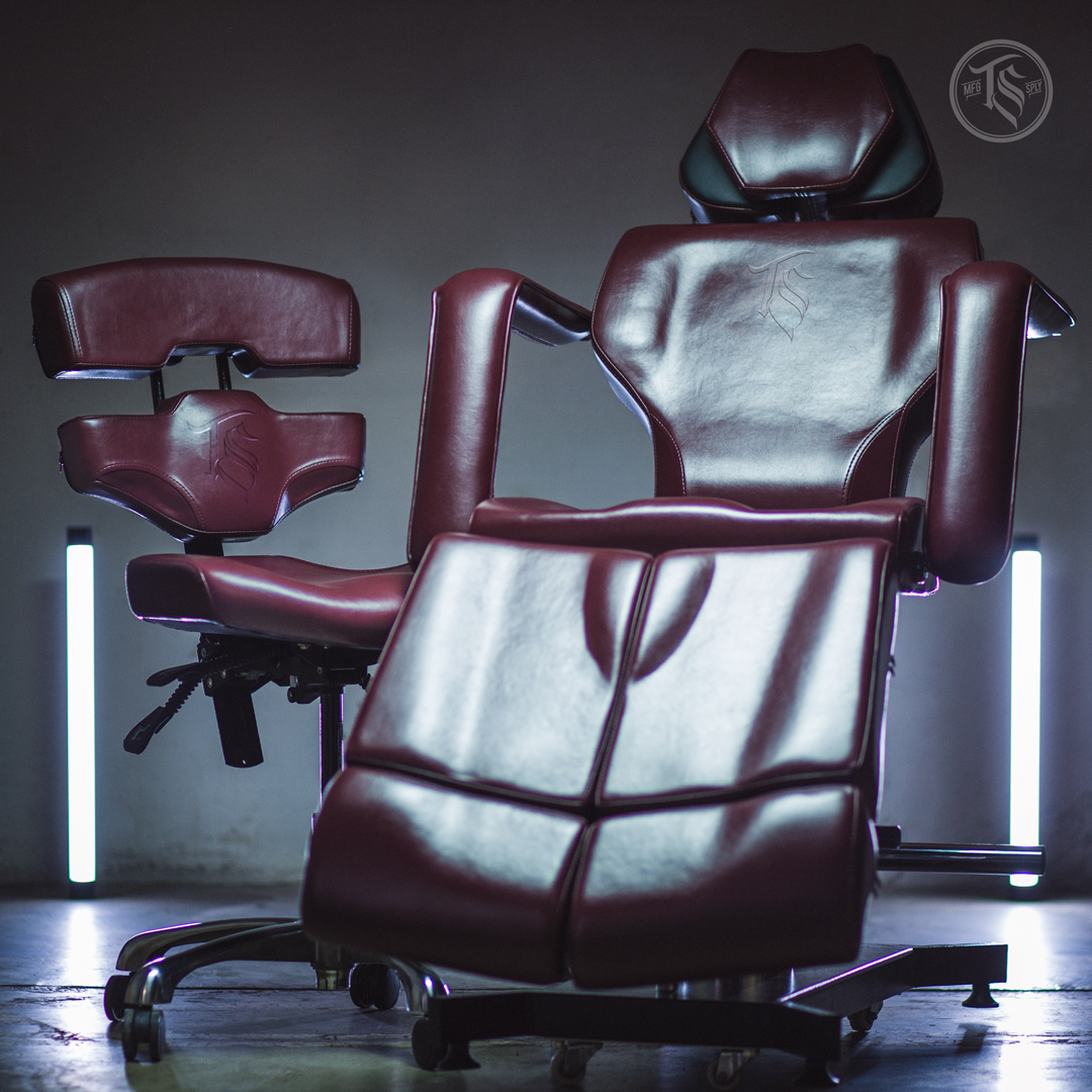 Two oxblood TATSoul tattoo chairs photographed with cyan and magenta practical lighting