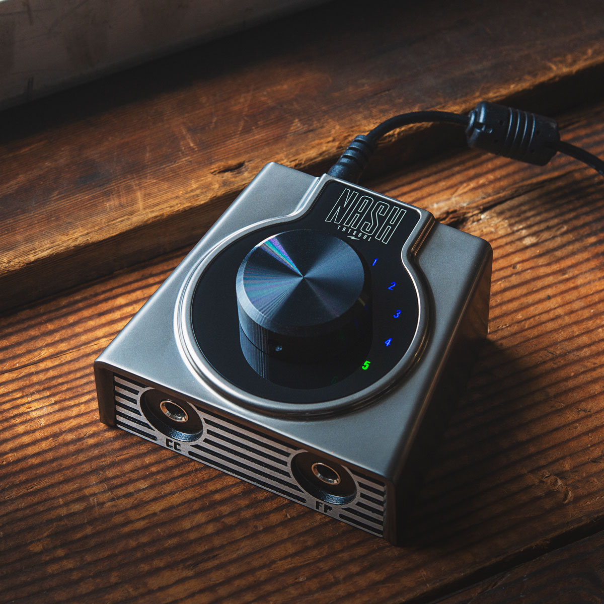 NASH by TATSoul tattoo power supply photographed on warm wood